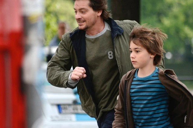 Louie and his film-father Fritz Karl dodge cars to have a boy's day together in Hamburg...